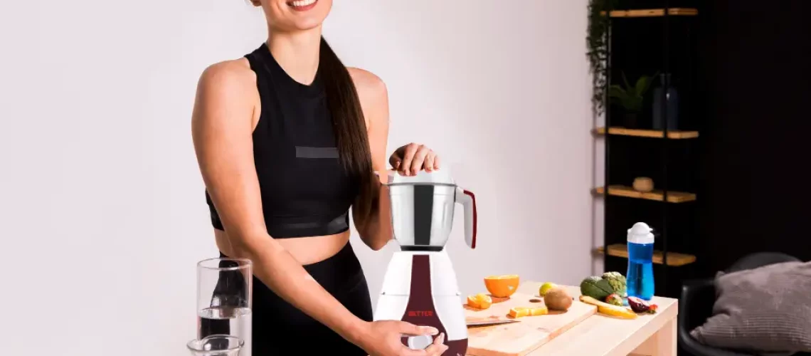 woman making smoothie in mixer grinder